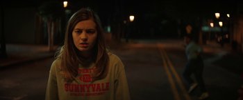 Movie still from “Fear Street: Part One - 1994” (2021), directed by Leigh Janiak – A woman standing on the side of a road at night; Close Up shot, Over the shoulder angle