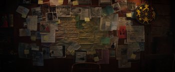 Movie still from “Fear Street: Part One - 1994” (2021), directed by Leigh Janiak – A wall covered with papers and notes on a wall; Extreme Close Up shot, High angle