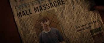 Movie still from “Fear Street: Part One - 1994” (2021), directed by Leigh Janiak – A newspaper with a picture of a young man in it; Extreme Close Up shot, High angle