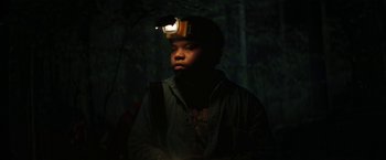 Movie still from “Fear Street: Part One - 1994” (2021), directed by Leigh Janiak – A man with a headlamp on his head in the dark; Close Up shot, Low angle