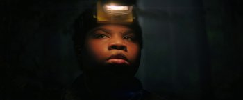 Movie still from “Fear Street: Part One - 1994” (2021), directed by Leigh Janiak – A man with a headlamp on his head looking up; Close Up shot, Low angle