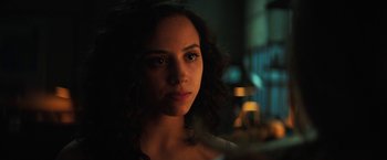 Movie still from “Fear Street: Part One - 1994” (2021), directed by Leigh Janiak – A person with long curly hair; Close Up shot, Over the shoulder angle