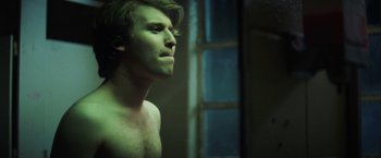 Movie still from “Fear Street: Part One - 1994” (2021), directed by Leigh Janiak – A man with a beard is standing in a room; Close Up shot, Over the shoulder angle