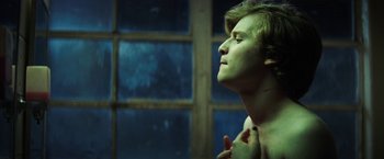 Movie still from “Fear Street: Part One - 1994” (2021), directed by Leigh Janiak – A young man is looking into a mirror; Close Up shot, Low angle