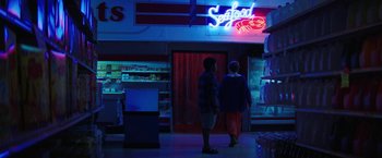Movie still from “Fear Street: Part One - 1994” (2021), directed by Leigh Janiak – Two people standing in front of a seafood store; Extreme Wide shot, Low angle