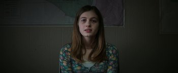 Movie still from “Fear Street: Part One - 1994” (2021), directed by Leigh Janiak – A woman with long hair wearing a floral shirt; Close Up shot, Over the shoulder angle