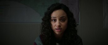 Movie still from “Fear Street: Part One - 1994” (2021), directed by Leigh Janiak – A person with curly hair; Close Up shot, Over the shoulder angle