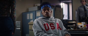 Movie still from “Fear Street: Part One - 1994” (2021), directed by Leigh Janiak – A man with a bandana on his head and wearing a sweatshirt; Close Up shot, Over the shoulder angle