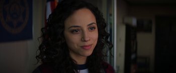 Movie still from “Fear Street: Part One - 1994” (2021), directed by Leigh Janiak – A person with curly hair; Close Up shot, Over the shoulder angle