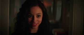 Movie still from “Fear Street: Part One - 1994” (2021), directed by Leigh Janiak – A person smiling for the camera; Close Up shot, Over the shoulder angle