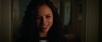 Movie still from “Fear Street: Part One - 1994” (2021), directed by Leigh Janiak – A person smiling for the camera; Close Up shot, Over the shoulder angle