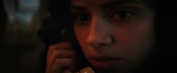 Movie still from “Fear Street: Part One - 1994” (2021), directed by Leigh Janiak – A person talking on a phone; Extreme Close Up shot, Low angle