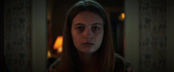 Movie still from “Fear Street: Part One - 1994” (2021), directed by Leigh Janiak – A young woman with long brown hair stares into the camera; Close Up shot, Low angle