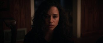 Movie still from “Fear Street: Part One - 1994” (2021), directed by Leigh Janiak – A person with curly hair; Close Up shot, Over the shoulder angle