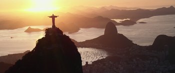 Movie still from “Mechanic: Resurrection” (2016), directed by Dennis Gansel – The sun is setting over a large body of water; Extreme Wide shot, Low angle