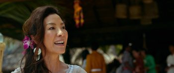 Movie still from “Mechanic: Resurrection” (2016), directed by Dennis Gansel – A person smiling; Close Up shot, Over the shoulder angle