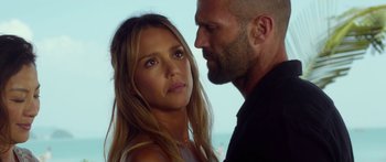 Movie still from “Mechanic: Resurrection” (2016), directed by Dennis Gansel – A man and a woman face to face in front of the ocean; Close Up shot, Over the shoulder angle