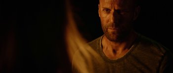 Movie still from “Mechanic: Resurrection” (2016), directed by Dennis Gansel – A person wearing a shirt; Close Up shot, Over the shoulder angle