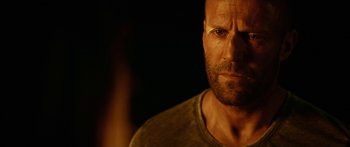 Movie still from “Mechanic: Resurrection” (2016), directed by Dennis Gansel – A person with a beard; Close Up shot, Over the shoulder angle