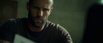 Movie still from “Mechanic: Resurrection” (2016), directed by Dennis Gansel – A person wearing a shirt; Close Up shot, Low angle