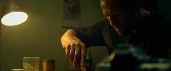 Movie still from “Mechanic: Resurrection” (2016), directed by Dennis Gansel – A person holding a toothbrush; Close Up shot, Low angle