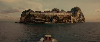 Movie still from “Mechanic: Resurrection” (2016), directed by Dennis Gansel – A boat is in the middle of a body of water; Extreme Wide shot, High angle