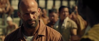 Movie still from “Mechanic: Resurrection” (2016), directed by Dennis Gansel – A person with a beard; Close Up shot, Over the shoulder angle