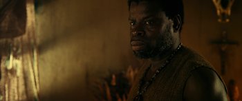 Movie still from “Mechanic: Resurrection” (2016), directed by Dennis Gansel – A man with a beard is looking at the camera; Close Up shot, Over the shoulder angle