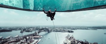 Movie still from “Mechanic: Resurrection” (2016), directed by Dennis Gansel – A man on a rope attached to a crane; Wide shot, Low angle