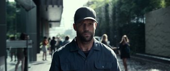 Movie still from “Mechanic: Resurrection” (2016), directed by Dennis Gansel – A man with a beard wearing a hat; Close Up shot, Low angle