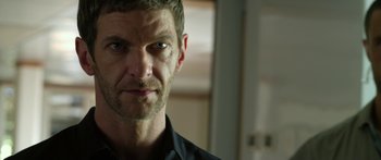 Movie still from “Mechanic: Resurrection” (2016), directed by Dennis Gansel – A person wearing a black shirt; Close Up shot, Over the shoulder angle