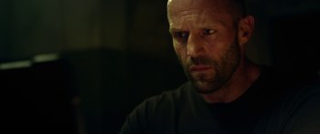 Movie still from “Mechanic: Resurrection” (2016), directed by Dennis Gansel – A person wearing a black shirt; Close Up shot, Low angle