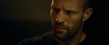 Movie still from “Mechanic: Resurrection” (2016), directed by Dennis Gansel – A man's face in a dimly - lit room; Close Up shot, Low angle