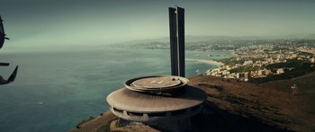 Movie still from “Mechanic: Resurrection” (2016), directed by Dennis Gansel – A building on top of a hill overlooking the ocean; Extreme Wide shot, Low angle