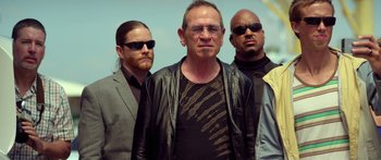 Movie still from “Mechanic: Resurrection” (2016), directed by Dennis Gansel – A group of men standing next to each other; Medium shot, Low angle