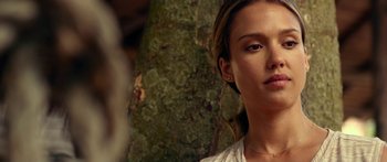 Movie still from “Mechanic: Resurrection” (2016), directed by Dennis Gansel – A woman's face in front of a tree; Close Up shot, Over the shoulder angle