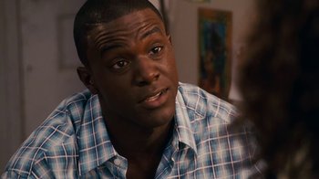 Movie still from “Meet the Browns” (2008), directed by Tyler Perry – A person wearing a plaid shirt; Close Up shot, Over the shoulder angle
