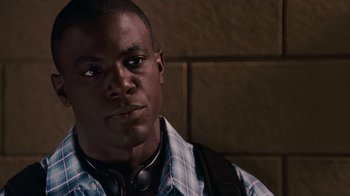Movie still from “Meet the Browns” (2008), directed by Tyler Perry – A person wearing headphones and looking at the camera; Close Up shot, High angle