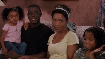 Movie still from “Meet the Browns” (2008), directed by Tyler Perry – A man and a woman are sitting on a couch; Medium shot, High angle