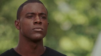 Movie still from “Meet the Browns” (2008), directed by Tyler Perry – A person wearing a black t - shirt; Close Up shot, Low angle