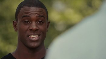 Movie still from “Meet the Browns” (2008), directed by Tyler Perry – A man smiling for the camera; Close Up shot, Over the shoulder angle