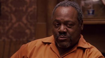 Movie still from “Meet the Browns” (2008), directed by Tyler Perry – An older black man wearing an orange shirt; Close Up shot, Over the shoulder angle