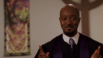 Movie still from “Meet the Browns” (2008), directed by Tyler Perry – A man in a suit and tie giving the peace sign; Medium shot, Low angle