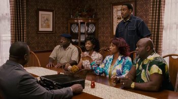 Movie still from “Meet the Browns” (2008), directed by Tyler Perry – A group of people sitting around a table; Medium shot, Over the shoulder angle
