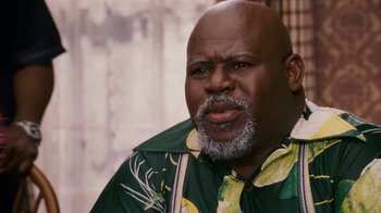 Movie still from “Meet the Browns” (2008), directed by Tyler Perry – An older man with a beard and a hawaiian shirt; Close Up shot, High angle
