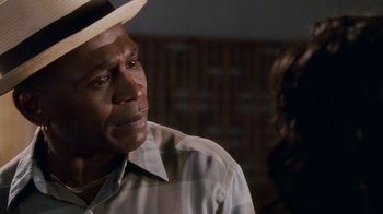 Movie still from “Meet the Browns” (2008), directed by Tyler Perry – An older man wearing a hat and a plaid shirt; Close Up shot, Over the shoulder angle