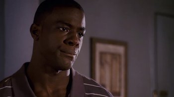 Movie still from “Meet the Browns” (2008), directed by Tyler Perry – A person wearing a striped shirt; Close Up shot, Over the shoulder angle