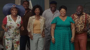 Movie still from “Meet the Browns” (2008), directed by Tyler Perry – A group of people standing next to each other in a room; Medium shot, Low angle