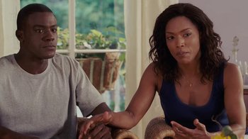 Movie still from “Meet the Browns” (2008), directed by Tyler Perry – A man and a woman sitting on a couch; Medium shot, Over the shoulder angle