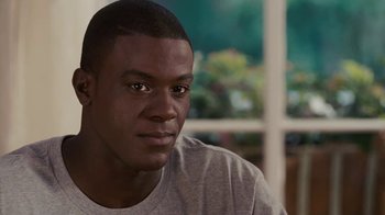 Movie still from “Meet the Browns” (2008), directed by Tyler Perry – A person wearing a gray t - shirt; Close Up shot, High angle
